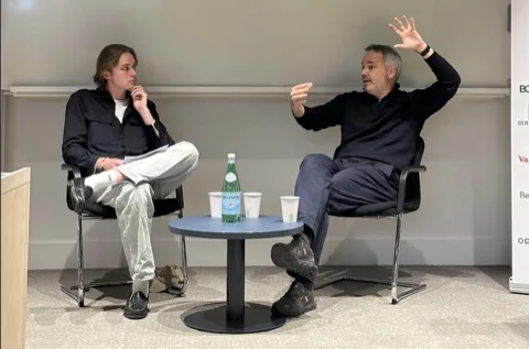 Josh de Buhr on stage with Heinemann at an LSE talk in 2026.