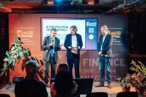 Josh de Buhr on stage with Greg Hands and Thomas Heilmann at the Big Bang KI Festival 2025.