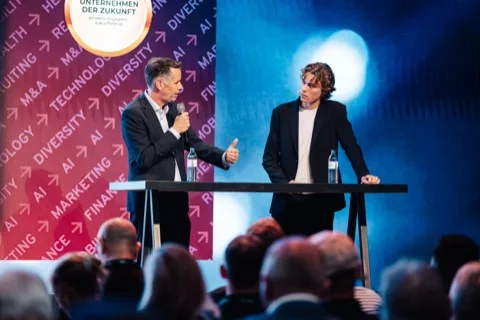 Josh de Buhr on stage with Christian Dürr at the Big Bang KI Festival 2025.